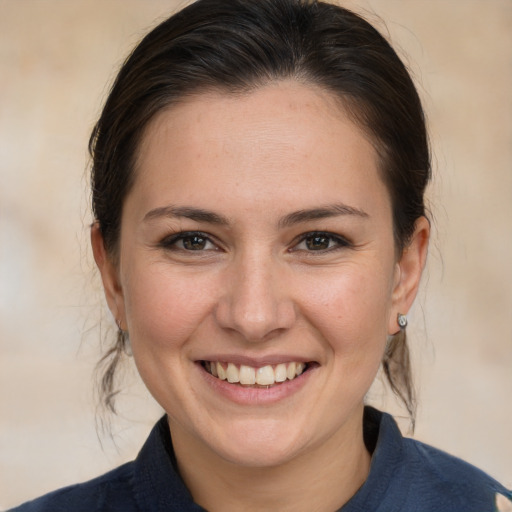 Joyful white young-adult female with medium  brown hair and brown eyes