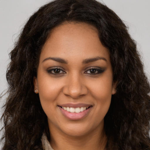 Joyful latino young-adult female with long  brown hair and brown eyes