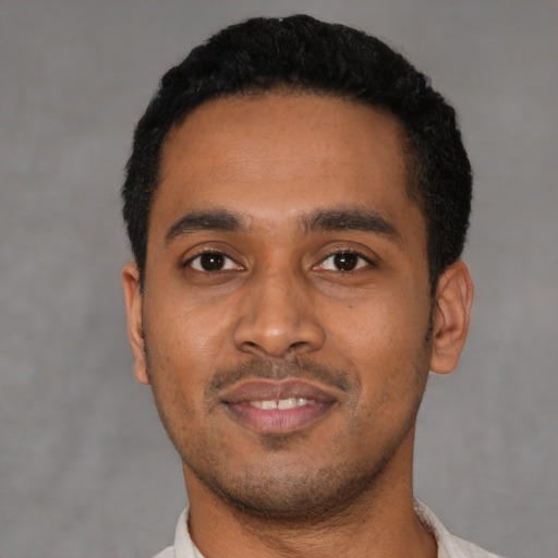 Joyful latino young-adult male with short  black hair and brown eyes