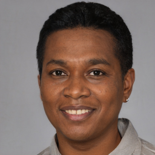 Joyful black young-adult male with short  black hair and brown eyes