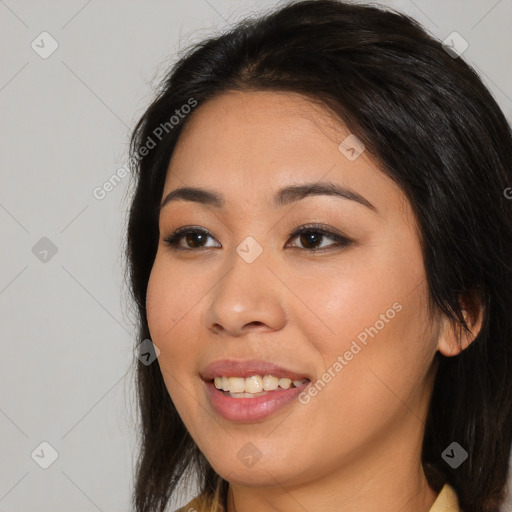 Joyful asian young-adult female with long  brown hair and brown eyes