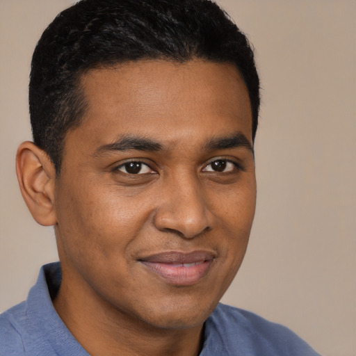 Joyful black young-adult male with short  brown hair and brown eyes