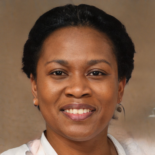 Joyful black adult female with short  brown hair and brown eyes
