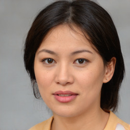 Joyful asian young-adult female with medium  brown hair and brown eyes