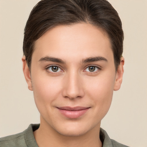 Joyful white young-adult female with short  brown hair and brown eyes