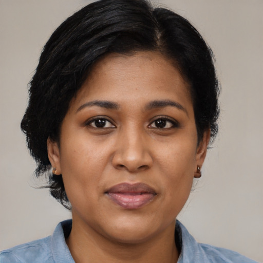 Joyful black young-adult female with medium  black hair and brown eyes