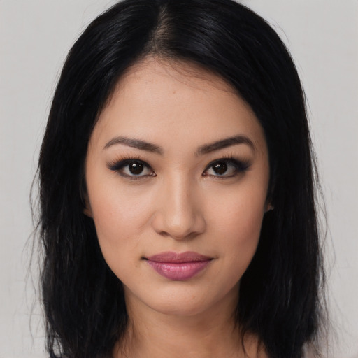 Joyful latino young-adult female with long  black hair and brown eyes