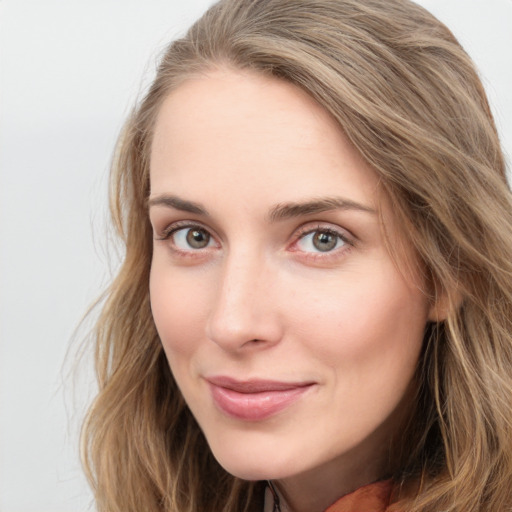 Joyful white young-adult female with long  brown hair and green eyes