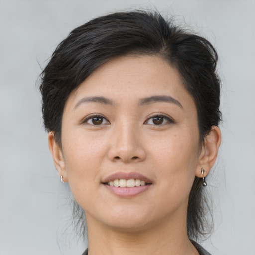 Joyful asian young-adult female with medium  brown hair and brown eyes