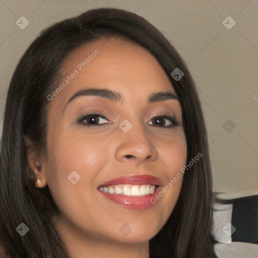 Joyful latino young-adult female with long  brown hair and brown eyes