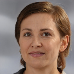 Joyful white adult female with medium  brown hair and brown eyes