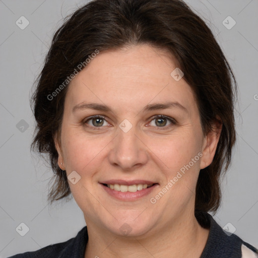 Joyful white adult female with medium  brown hair and grey eyes