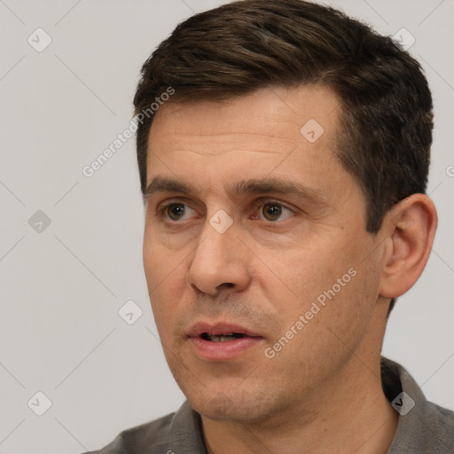 Joyful white adult male with short  brown hair and brown eyes