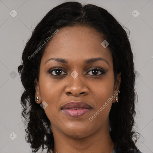 Joyful black young-adult female with long  brown hair and brown eyes