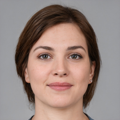 Joyful white young-adult female with medium  brown hair and grey eyes