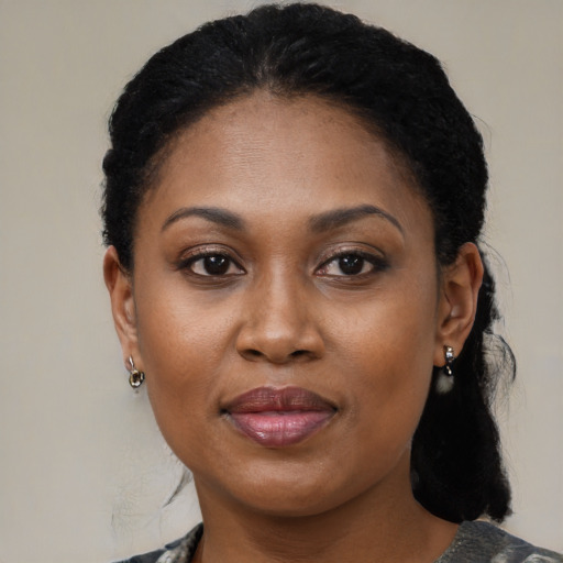 Joyful black adult female with medium  black hair and brown eyes