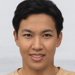 Joyful asian young-adult male with short  brown hair and brown eyes