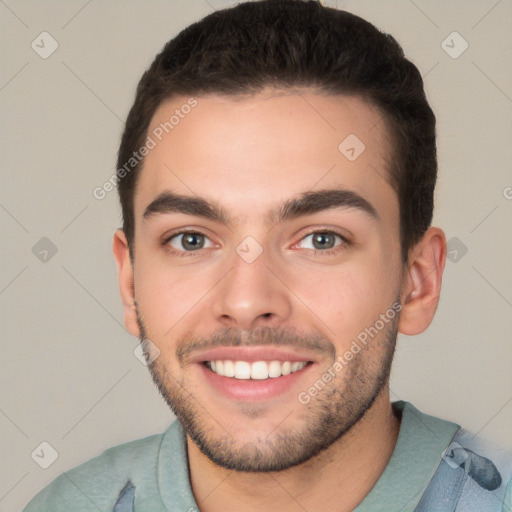 Joyful white young-adult male with short  brown hair and brown eyes