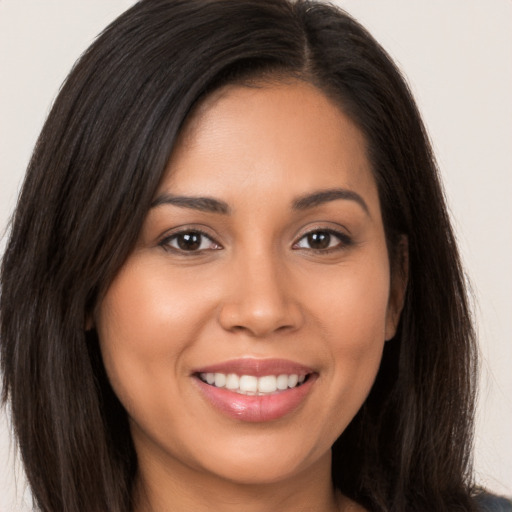 Joyful white young-adult female with long  brown hair and brown eyes