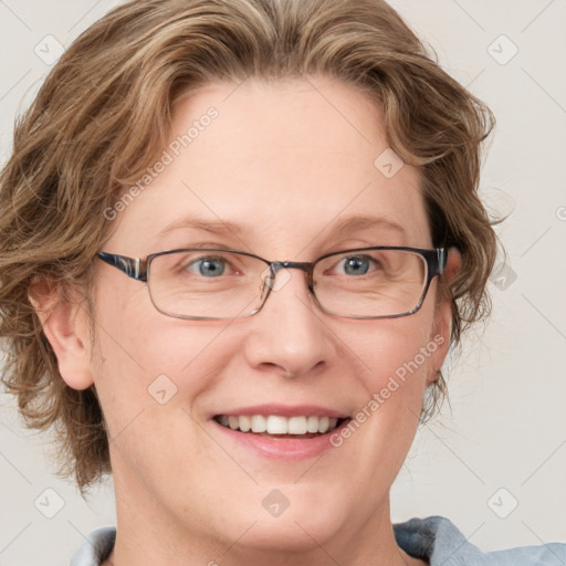 Joyful white adult female with medium  brown hair and blue eyes