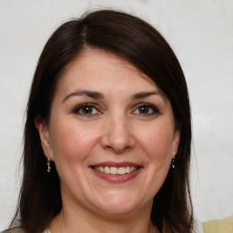 Joyful white adult female with medium  brown hair and brown eyes