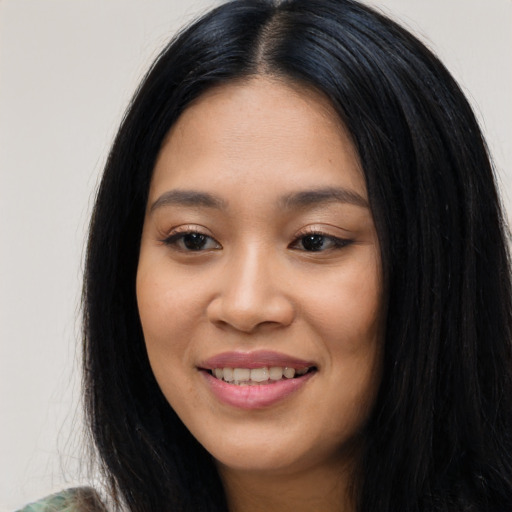 Joyful latino young-adult female with long  black hair and brown eyes