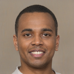 Joyful latino young-adult male with short  brown hair and brown eyes