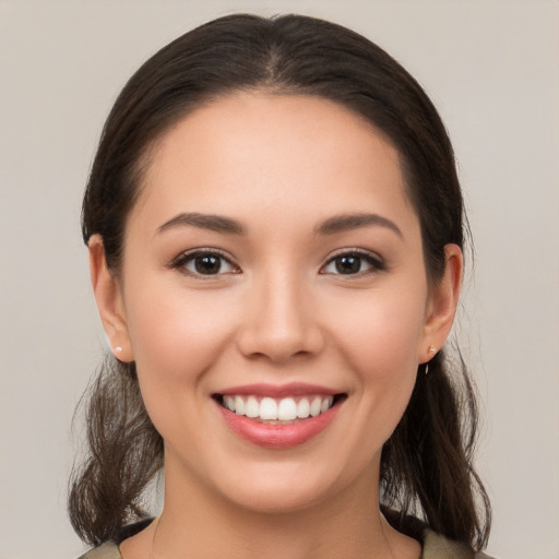 Joyful white young-adult female with medium  brown hair and brown eyes