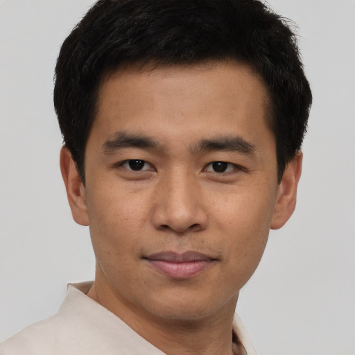 Joyful latino young-adult male with short  brown hair and brown eyes