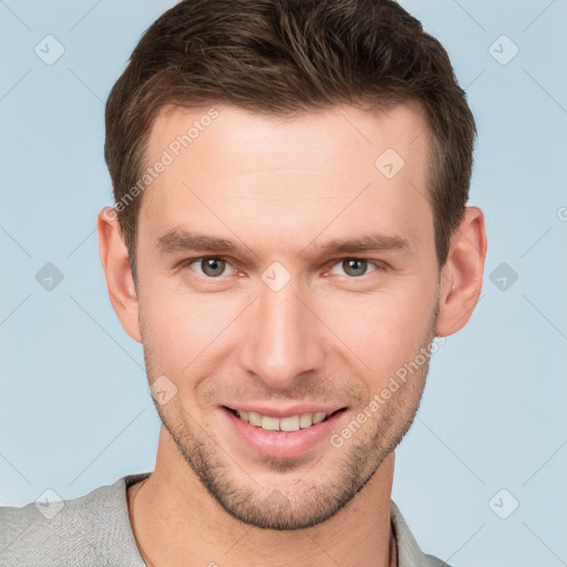 Joyful white young-adult male with short  brown hair and grey eyes