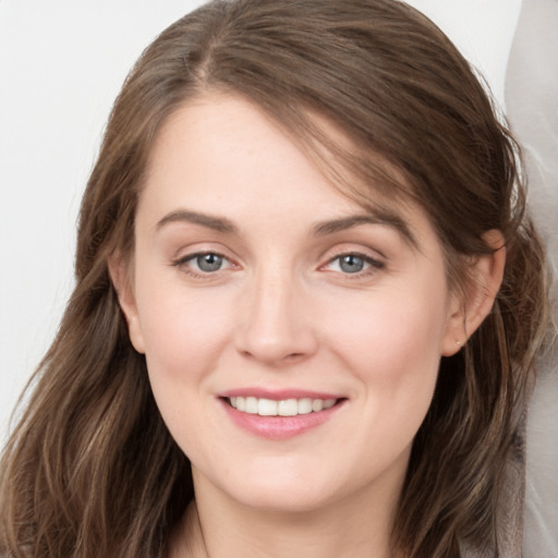 Joyful white young-adult female with long  brown hair and grey eyes