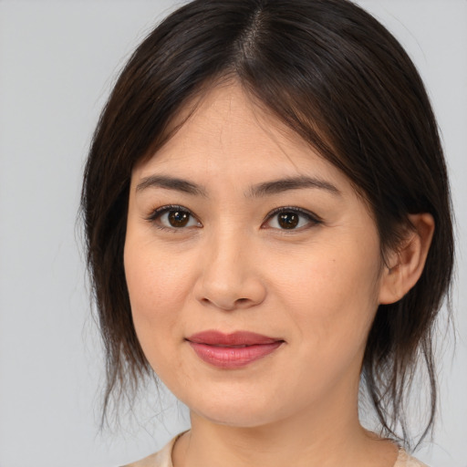 Joyful asian young-adult female with medium  brown hair and brown eyes