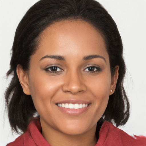 Joyful latino young-adult female with long  brown hair and brown eyes