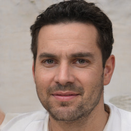 Joyful white adult male with short  brown hair and brown eyes