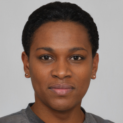 Joyful black young-adult female with short  black hair and brown eyes