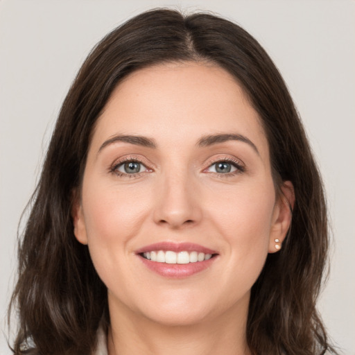 Joyful white young-adult female with medium  brown hair and grey eyes