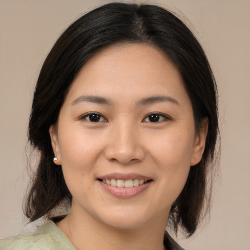 Joyful asian young-adult female with medium  brown hair and brown eyes