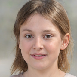 Joyful white child female with medium  brown hair and brown eyes