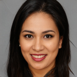 Joyful white young-adult female with long  brown hair and brown eyes