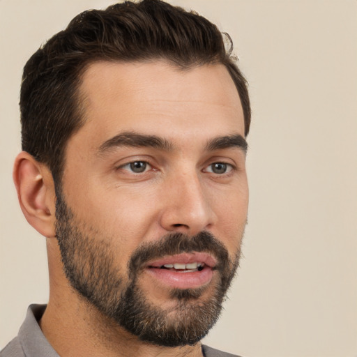 Joyful white young-adult male with short  black hair and brown eyes