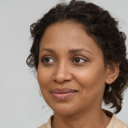 Joyful black young-adult female with medium  brown hair and brown eyes