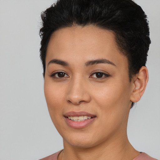 Joyful latino young-adult female with short  black hair and brown eyes