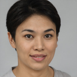 Joyful asian young-adult female with short  brown hair and brown eyes