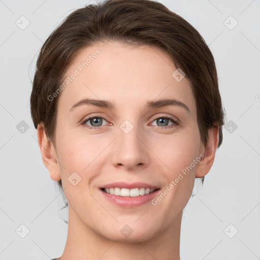 Joyful white young-adult female with short  brown hair and grey eyes