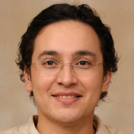 Joyful white adult male with medium  brown hair and brown eyes