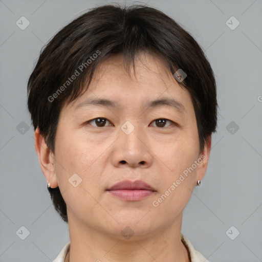 Joyful asian adult male with short  brown hair and brown eyes