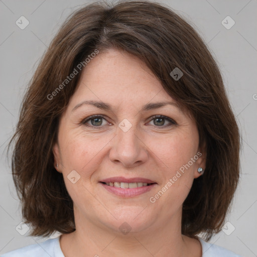 Joyful white adult female with medium  brown hair and grey eyes