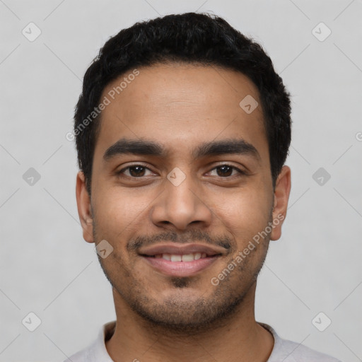 Joyful latino young-adult male with short  black hair and brown eyes