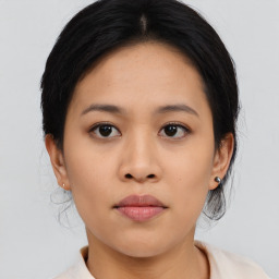 Joyful asian young-adult female with medium  black hair and brown eyes