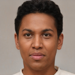 Joyful latino young-adult male with short  brown hair and brown eyes